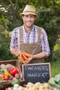 Farmer selling organic veg at market Royalty Free Stock Photo