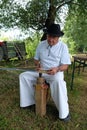 Farmer sharpening his scythe