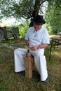 Farmer sharpening his scythe