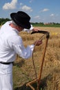 Farmer sharpening the scythe