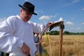 Farmer sharpening the scythe