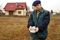 Farmer shoving polish currency