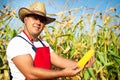 Farmer showing corn maize ear at field Royalty Free Stock Photo