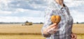 A farmer shows a heart-shaped potato