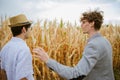 The farmer shows the insurer the drought damage to his corn field. Drought concept