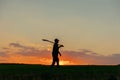 farmer silhouette with shovel walk on the agricultural industry concept.