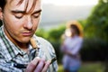 Farmer sniffing wine cork to test the quality of the wine