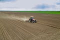 Farmer sowing crops at field with tractor Royalty Free Stock Photo