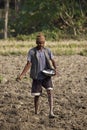 Farmer sowing seeds in his field