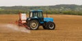 A farmer spraying with a Landini Evolution 9880 tractor.