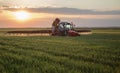 Farmer spraying wheat field