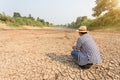 Farmer stand in the dry river and looking to empty water in Sukhothai. For drought season concept