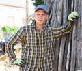 Farmer standing on backyard of farm during break from work Royalty Free Stock Photo