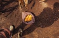 Farmer standing directly above harvested corn cobs in burlap sac