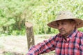 Farmer standing on a farm, he is pensive