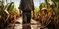 Farmer standing in a flooded cornfield, reflecting on climate change\'s impact on agriculture Royalty Free Stock Photo