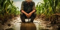 Farmer standing in a flooded cornfield reflecting on climate changes impact on agriculture food security and rural economy Royalty Free Stock Photo