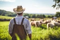 Farmer standing in front of a herd of sheep on a sunny day Royalty Free Stock Photo