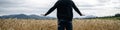 Farmer standing in the middle of olden wheat field holding his hands above the ripening ears Royalty Free Stock Photo