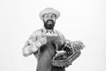 Farmer straw hat hold eggplant and basket vegetables. Fresh organic vegetables wicker basket. Man bearded presenting Royalty Free Stock Photo