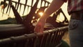 Farmer stroking hand combine agronomic at golden countryside sunset field