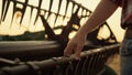 Farmer stroking hand combine agronomic at golden countryside sunset field Royalty Free Stock Photo