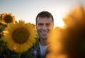 Farmer in sunflower field at sunset Royalty Free Stock Photo
