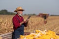 Farmer with tablet on corn harvesting Royalty Free Stock Photo