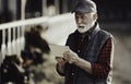 Farmer with tablet in front of cows Royalty Free Stock Photo