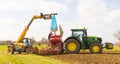 Farmer with a telehandler loading seeds into a seeder driller attached to a tractor. UK Royalty Free Stock Photo