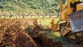 Farmer tills the soil with the crawler tractor. Agriculture Royalty Free Stock Photo