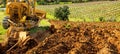 Farmer tills the soil with the crawler tractor. Agriculture Royalty Free Stock Photo