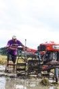 A farmer is tiring a rice field