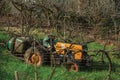 Farmer on a tractor amid rows of grapevines