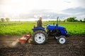 A farmer on a tractor cultivates a field. Farm work. Milling soil, Softening the soil before planting new crops. Farming. Plowing Royalty Free Stock Photo