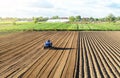 Farmer on a tractor cultivates land after harvesting. Mechanization, development of agricultural technologies. Grinding loosening