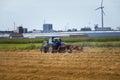 Farmer on tractor cutting hay in farm field in maassluis, Royalty Free Stock Photo