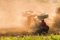 Farmer tractor with disc harrow system working on a stubble field Royalty Free Stock Photo