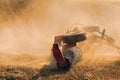 Farmer tractor with disc harrow system working on a stubble field Royalty Free Stock Photo