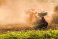 Farmer tractor with disc harrow system working on a stubble field Royalty Free Stock Photo