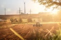 Farmer on a tractor harvesting in a field in bright sunshine Royalty Free Stock Photo