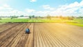 Farmer on tractor loosens and grinds the soil. Preparing the land for a new crop planting. Farming and agriculture. agricultural Royalty Free Stock Photo