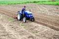 Farmer on a tractor loosens soil with milling machine. Plowing field. First stage of preparing soil for planting. Loosening Royalty Free Stock Photo