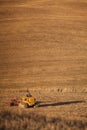 Farmer tractor plowing wheat stubble field and.cultivating, agriculture