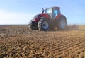 Farmer on tractor prepares land in spring