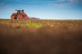 Farmer in tractor preparing land with seedbed cultivator