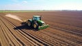 Farmer in tractor preparing land with seedbed cultivator as part of pre seeding activities in early spring season of agricultural