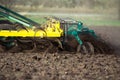 Farmer in tractor preparing land with seedbed cultivator in early spring