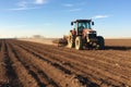 Farmer in tractor preparing land with seedbed cultivator at spring, Application of manure on arable farmland, AI Generated