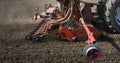 Farmer with tractor seeding crops at field Royalty Free Stock Photo